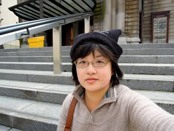 Lisa wearing cat hat, sitting on the steps of Usher Hall