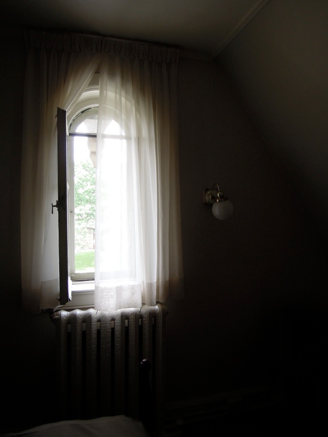Sheer curtain over an open window